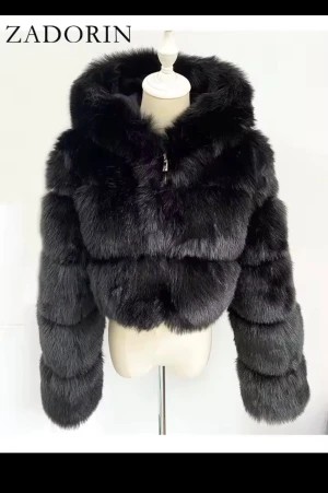 Svart croppad pälsjacka från Zadorin - Säljer en svart croppad pälsjacka från Zadorin med fluffig huva och dragkedja framtill. Jackan har långärmade, voluminösa ärmar och en riktigt lyxig look. Perfekt för dig som vill sticka ut med en statement piece i garderoben.