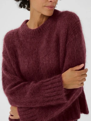 Vinröd stickad mohair tröja - Säljer en vinröd stickad tröja från Part Two i storlek S. Tröjan har en rund halsringning och långa ärmar med breda ribbade muddar. Materialet är mjukt och fluffigt, perfekt för kyliga dagar och julen. 