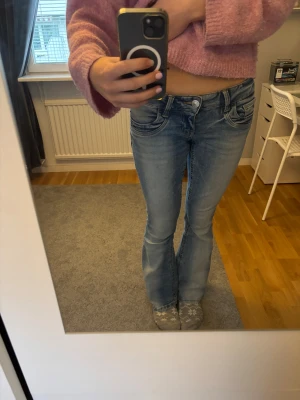 Bootcut ljusblå jeans💕 - Säljer ett par snygga ljusblå bootcut jeans med slitna detaljer på, det har en lite blå fläck från ett nagellack som nästan inte syns. Det är väldigt stretchinga , men är tyvärr för små för mig i längden💕 jag är 173 cm lång🥰🤗