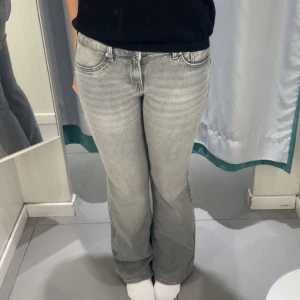 Grå bootcut jeans - Säljer ett par grå jeans med bootcut-modell. 