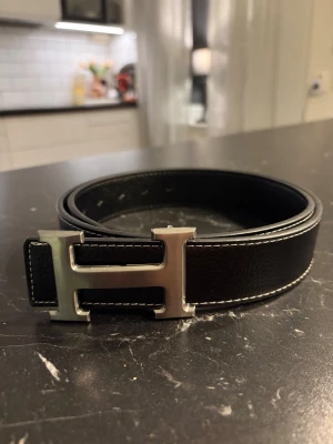 Svart H-bälte - Säjer ett svart H-bälte. 110 cm långt men finns möjlighet till att göra hål. Bältet ger en riktigt stilig och erfaren look. Perfekt för dig som söker något elegant i vardagen. Vid frågor är det bara o höra av sig👍☺️