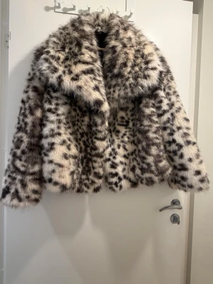 Leopardmönstrad pälsjacka från Zara - Säljer en fluffig och oversized pälsjacka från Zara i storlek M. Jackan har ett snyggt leopardmönster i svart och beige, bred krage och stängs med hyska. Perfekt statement-plagg för dig som vill sticka ut i vinter!