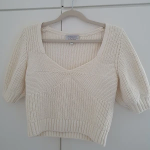 Krämvit stickad topp  - Krämvit stickad topp från Los Angeles Atelier med v-ringning. Snygg ribbad kant nertill och vid ärmslut. Knappt använd och är i ett bra skick. 