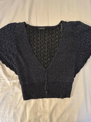 glittery cropped knitted cardigan - black glittery cropped knitted cardigan with short, wide sleeves. Tag says L but it fits like M 