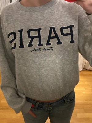 Grå sweatshirt med PARIS-tryck - Så fin grå sweatshirt med Paris tryck på kommer aldrig till användning ❤️