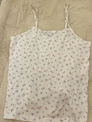 Vit blommig linnetopp med spetskant - Söt vit linnetopp med små blommor i rosa och blått, brandy mellvie liknande💕