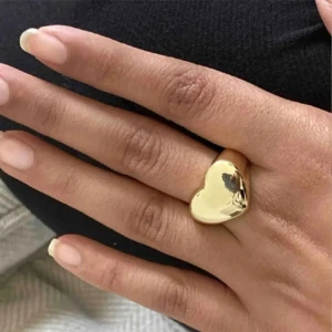 Guldfärgad hjärtring - Guld ring med ett stort hjärta. Ringen går att ända i storlek på baksidan. Perfekt accessoar för dig som vill sticka ut med en söt detalj på handen.