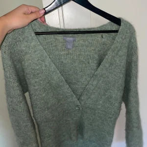 Grön stickad kofta - En fin grön stickad kofta från Lindex. Det är en mysig kofta som är lite tajtare runt midjan, pris kan diskuteras!