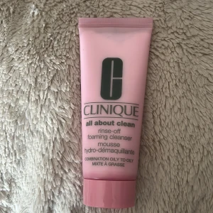 Clinique All About Clean Foaming Cleanser - Rosa tub med Clinique All About Clean rinse-off foaming cleanser, 75 ml. Perfekt för kombinerad till oljig hud, allergitestad och helt parfymfri. Löddrande mousse som tar bort smink, smuts och överflödigt fett utan att torka ut huden. Snygg och stilren design. testat en gång 