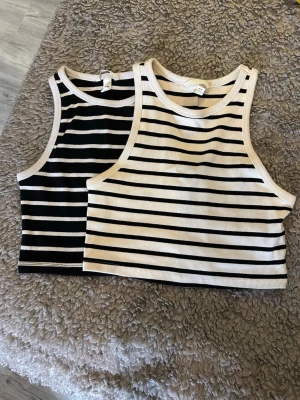 Ribbade toppar - 2 ribbade toppar i vit och svart. Båda har använts fåtal gånger och är i mycket bra skick!