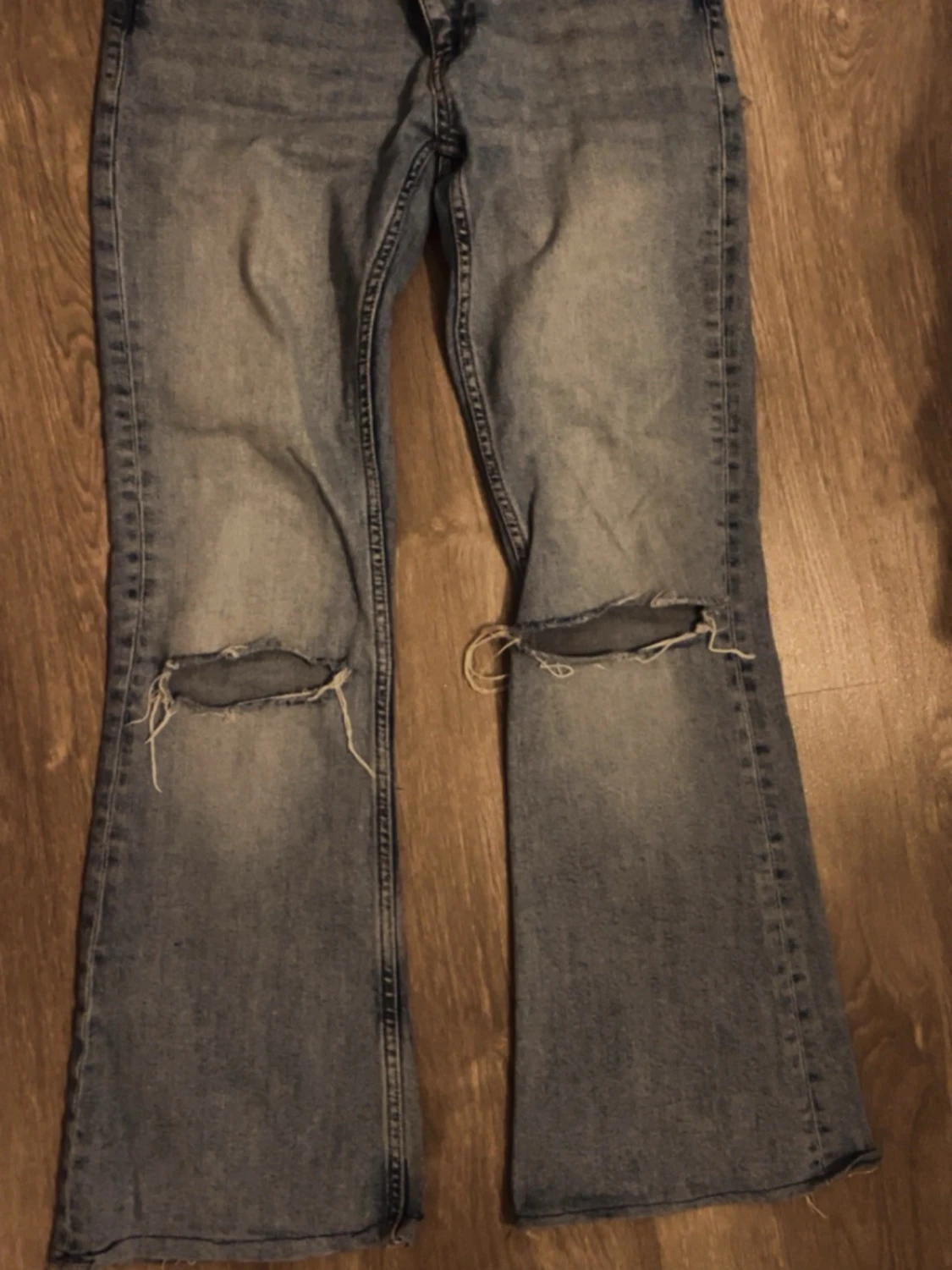 Blå bootcut jeans med slitna knän