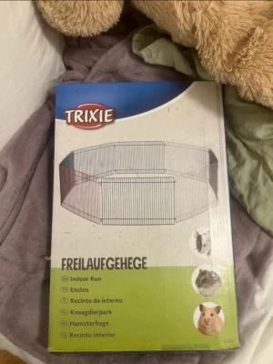 Hamsterhage - Säljer nu en hamsterhage som har kommit till användning endast en gång. Kartongen är lite sönder men stängslet funkar hur bra som helst. Denna uppskattas och hamstrar tycker det roligt att kunna springa runt i en hage som är stor, man kan även sätta ut olika hjul och leksaker för att smådjuren ska uppskatta det mer. Måtten är 34x23cm och det är 8 delar. Hagen är ifrån märket TRIXIE. Jag köpte denna på ArkenZoo för 240kr men säljer för 150kr.🌸Denna passar perfekt för smådjur som tex hamstrar.