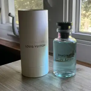 Säljer en lyxig parfym från Louis Vuitton, 'Imagination' 100ml. Flaskan är elegant med en ljusblå vätska och svart kork. Kommer i en stilren vit förpackning med märkets logga. Louis Vuittons mest eftertraktade parfym. Nypris 3400kr. Perfekt för den som vill ha en exklusiv doftupplevelse. Passar både till vardags och speciella tillfällen. Skriv vid funderingar