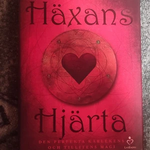 Häxans Hjärta bok - Säljer boken 'Häxans Hjärta' från LivsEnergi. Den har en röd omslagsdesign med ett hjärta i mitten och mystiska symboler runtom. Perfekt för dig som är intresserad av kärlekens och tillitens magi. Boken är i gott skick och redo att förtrolla sin nästa läsare. 📚❤️