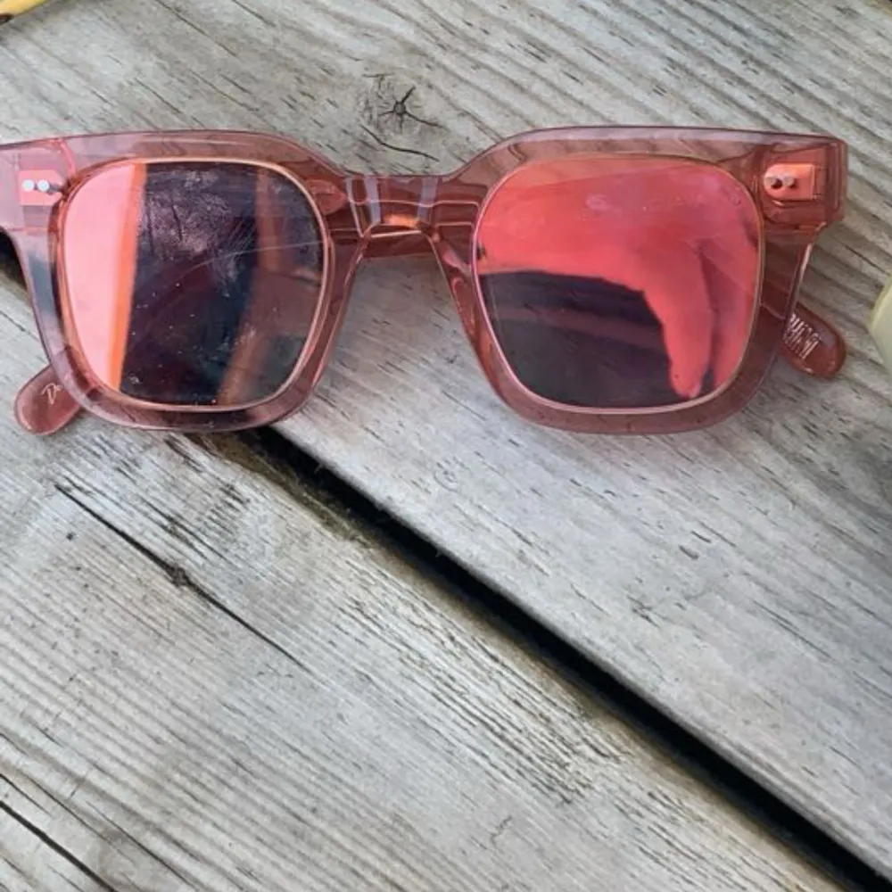 Snygga rosa solglasögon från chimi med transparent båge och gula linser. Perfekta för en solig dag och ger en cool touch till din outfit. De har en klassisk fyrkantig form som passar de flesta ansikten.. Asusteet.
