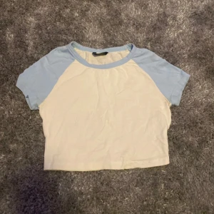 💙Magtröja🤍 - Säljer en söt vit och ljusblå kortärmad topp med rund halsringning. 