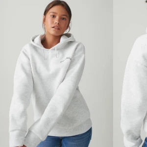 Grå hoodie med tryck - Säljer en grå hoodie med texten 'Ma chérie' och ett hjärta med pil på ryggen. Hoodien är i fint skick och har inte användts många gånger,  säljes för 190kr ord pris 250kr