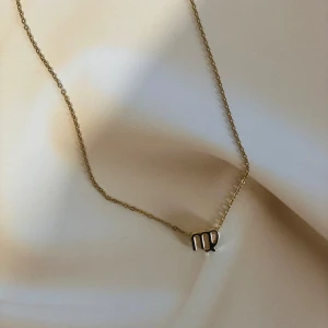 Halsband med stjärnteckenberlock - Snyggt och stilrent halsband med en berlock i form av stjärntecknet Jungfrun. Perfekt för att ge en personlig touch till din outfit. Kedjan är tunn och elegant, vilket gör den lätt att bära till vardags eller vid speciella tillfällen. Rostfritt stål 