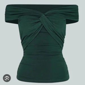 Off-shoulder topp - Snygg och festlig grön off-shoulder topp. Knutdetalj framtill, med ett stretchigt material. Helt oanvänd med prislapp kvar, därav säljer jag den. Storlek L, men skulle säga att den även passar mindre. (Lånade bilder)