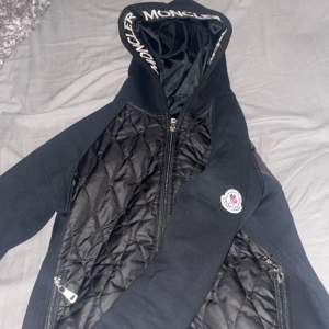 Säljer en snygg svart quiltad jacka från Moncler. Den har en design med dragkedja och Moncler-logga på bröstet. Jackan är i mycket bra skick och perfekt för höst och vår. Säljer för jag inte behöver. Pris kan diskuteras 