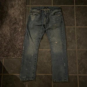 Blåa Ralph Lauren Jeans: Storlek 30x30 - Säljer ett par blå Ralph Lauren Jeans i helt nytt skick ”aldrig använda” med coola slitningar. Storlek 30x30 slim straight fit. Goa jeans till hösten/vintern. Nypris 1899kr