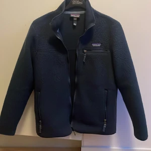 Mörkblå fleecejacka från Patagonia - Säljer en snygg mörkblå fleecejacka från Patagonia i storlek S. Jackan har en dragkedja framtill och praktiska fickor med dragkedjor. Perfekt för kyliga höst- och vinterdagar. Den är som helt ny köpte den för 1 månad sen! Köptes för 1699 men säljer för endast 999!