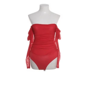 Röd body från NLY One - Snygg röd bodysuit från NLY O med rynkade detaljer. Tillverkad i ett mjukt och stretchigt material med mesh-inslag. Perfekt för en trendig look!