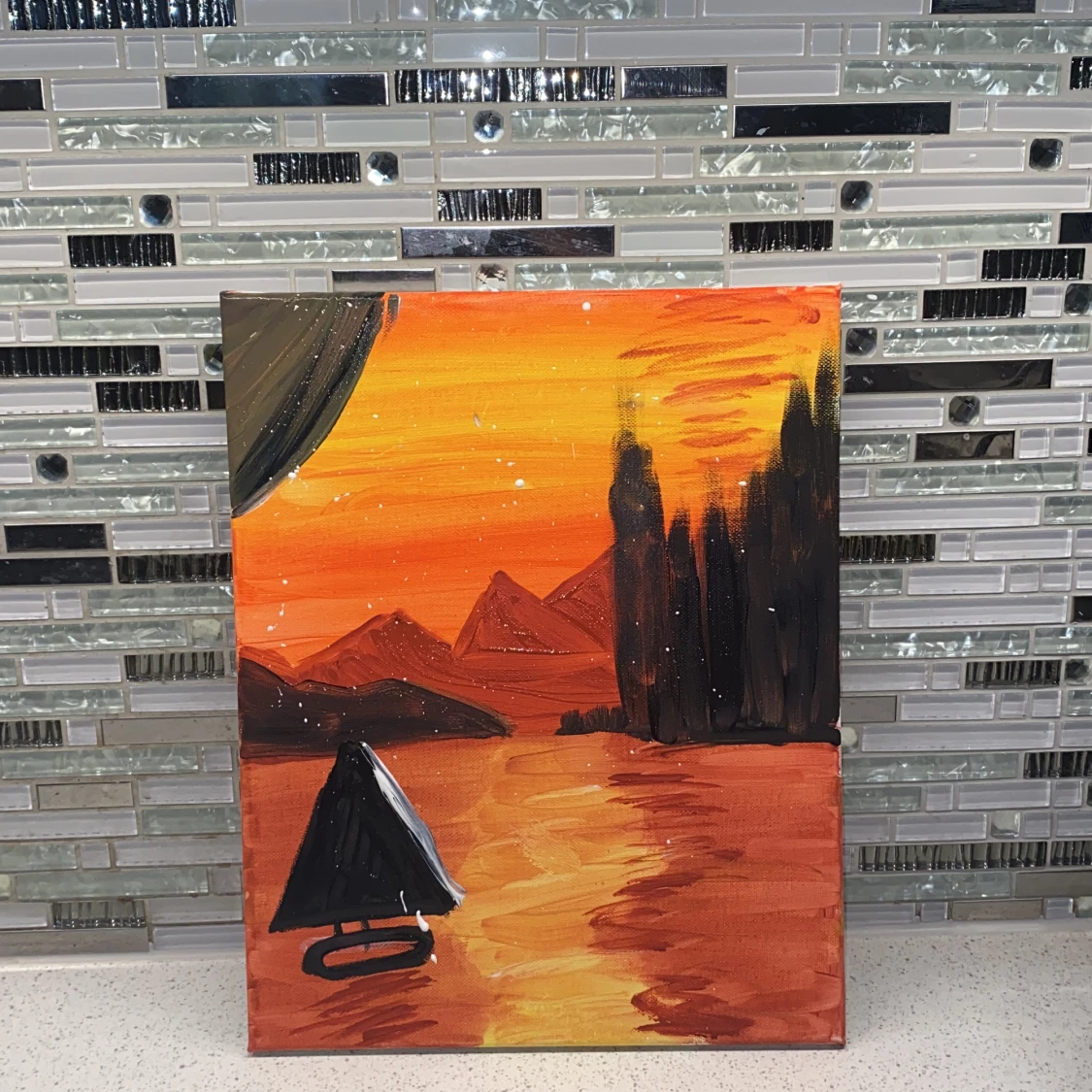 Målning av solnedgång över sjö