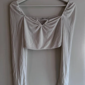 Vit långärmad topp från Zara - Säljer en stilren vit långärmad topp från Zara.   Rensar ur min garderob just nu🌼 Kika och se om du ser något mer i min profil som du gillar så skickar jag med det till dig också!😊 Fler kläder kommer! 