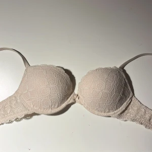 Beige spets-bh - Beige bh med spetsdetaljer och justerbara axelband. Den är i storlek 70 B och bara använd ett fåtal gånger. Pushup-bh från Instimissimi