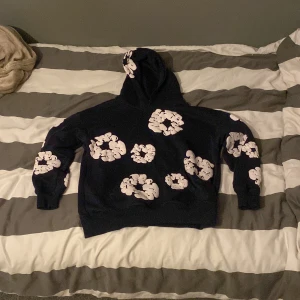 Marinblå hoodie från Denim Tears - Säljer en marinblå hoodie från Denim Tears med blommor runt hela hoodien köpt här på Plick. Storlek s. Priset går att diskuteras 