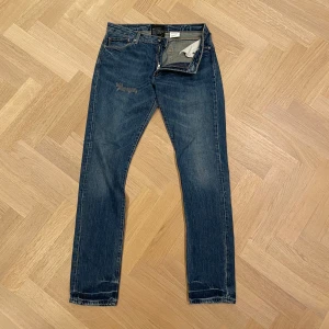 Blå jeans från Acne Studios - Snygga blå jeans från Acne Studios med klassisk femficksdesign och dragkedja. De har en slim/straight passform och en slitning på högra låret. Passar dig som är ca 185cm lång. Hör gärna av er i dm för exakta mått, fler bilder eller funderingar🤗