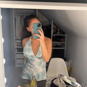 Blåmönstrad halterneck-top - Säljer en superfin blåmönstrad halterneck-top med öppen rygg. Perfekt för sommardagar eller en festkväll. Toppen har ett mjukt, flödande material och ett snyggt mönster i ljusblått och vitt. Den är både bekväm och stilren, och passar perfekt till jeans eller kjol! Aldrig använd och i mycket bra skick saknar dock prislapp! Köptes för 500 säljs för 180🥰bemärks i storlek XS/S