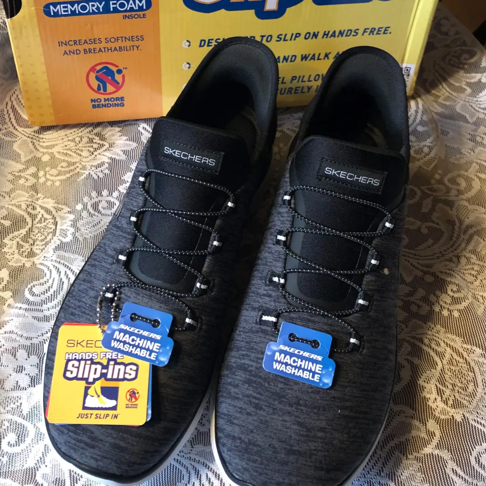 Säljer ett par svarta slip-ins från Skechers med Air-Cooled Memory Foam för extra komfort. Skorna är maskintvättbara och har en snygg, modern design med elastiska snören för enkel påtagning. Perfekta för vardagsbruk och ger en skön känsla hela dagen. Nypris 1400:-. Bred modell. Kan passa även en 40,5.. Skor.