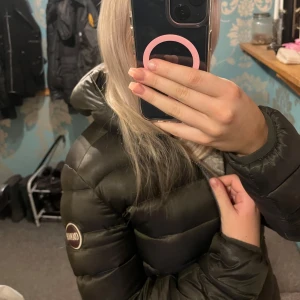 Mörkgrön dunjacka från Colmar - Säljer en snygg mörkgrön dunjacka från Colmar i mycket bra skick. Jackan har en dragkedja framtill och två praktiska fickor med dragkedjor. Perfekt för höst och vinter, håller dig varm och stilren.  Är i storlek 42 som motsvarar storlek s🌸