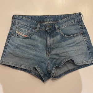 Blå jeansshorts från Diesel - Snygga blå jeansshorts från Diesel, midrise midja och klassisk femficksdesign. Perfekta för sommardagar med en avslappnad stil. Slitna detaljer ger en cool vintage-look. De kostar 1600kr på hemsidan. Om man är intresserad så kan jag skicka fler bilder och mått.