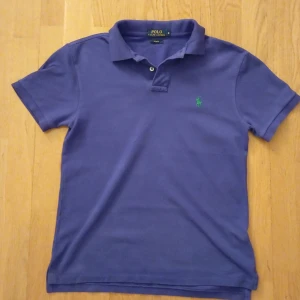 Lila pikétröja från Ralph Lauren - Säljer en lila pikétröja från Ralph Lauren. I slim fit model. Tröjan har inga defekter. Köpt Ralph Lauren butiken. Ordinarie pris 1200 kr