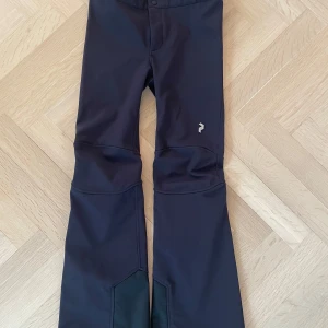 Svarta byxor från Peak Performance - Snygga svarta byxor från Peak Performance med en stilren design. Perfekta för utomhusaktiviteter med en bekväm passform och slitstarkt material. Storlek 150 junior. Nypris 1800 köpta förra året och modellen är inte tillgänglig längre.