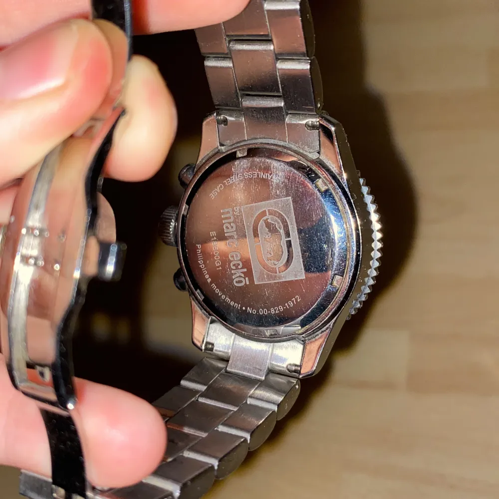 Snygg silverfärgad klocka ifrån Marc Ecko med strass runt urtavlan. Klockan har en robust länkarmband och flera små urtavlor inuti. Perfekt för den som gillar en glittrig och iögonfallande stil. Passar bra till både vardag och speciella tillfällen.. Asusteet.