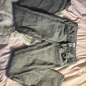 Grå jeans från Gina Tricot - Snygga grå jeans från Gina Tricot med en klassisk femficksdesign. De har en rak passform och är tillverkade i ett slitstarkt denimtyg. Perfekta för en avslappnad stil. Små slitningar på nedre delen av jeansen (bild 4)