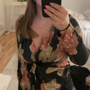 Blommig omlottopp/blus från intemissemi  - Säljer denna superfina blommiga omlottopp/blusen från intemissemi som inte längre går att köpa. Helt som ny då den knappt är använd!! Den har en knytning i midjan som ger en smickrande passform. Perfekt för både vardag och fest!💖💖