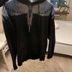Marcelo Burlon Hoodie - Säljer min Marcelo Burlon hoodie i relativt bra skick. Äkta. Har tyvärr inget kvitto. Ganska bra skick, lite solblekt samt ett litet hål där bak som ej syns så väl. Storlek M-L.