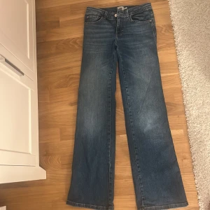 Blå bootcut jeans från 157 - Snygga blå bootcut jeans från 157 i storlek XS. De har en klassisk femficksdesign och stängs med dragkedja och knapp. Perfekta för en avslappnad stil med en touch av 90-tal. Helt nya säljs pga av att dom var förstora.