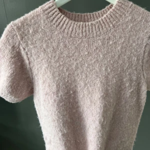 Ljusrosa stickad tröja - Mysig ljusrosa stickad tröja med korta ärma från Gina tricot. Lite nopprig som ni ser
