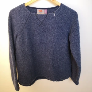 Tröja i ullmix från Varg - Denim blå tröja i ullmix från Varg kläder. Storlek Small. Nypris 2000 kr. Dragkedja som kan öppna upp halskanten på axelsömmen. Köparen står för fraktkostnaden. 