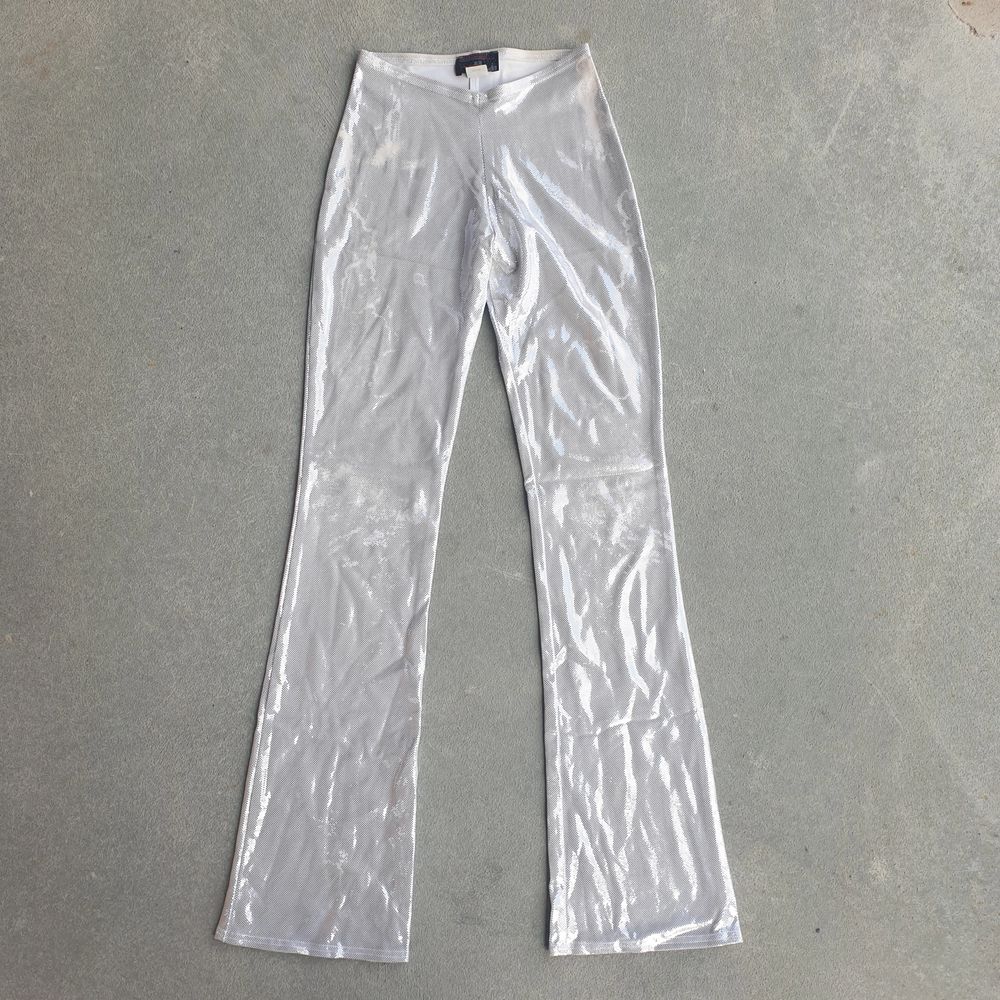 Super gorgeous fit, silver sparkly flare pants. Made in New York City. Small wear on the sparkly design in some areas but it doesn't take away from the gorgeous y2k energy. Matching top sold in separate listing!. Jeans & Byxor.