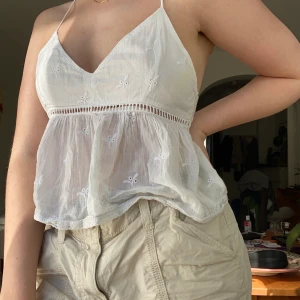 Vit sommartopp - Supersöt och sval topp från Hollister. Knappt använd men har blivit förliten. Fint skick bortsett från en gul solkrämsfläck vid armhålan. 