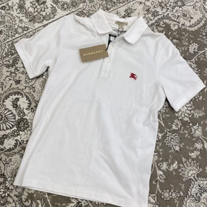 Vit piké från Burberry i storlek S - Helt ny och oanvänd vit piké från burberry. Äkta. Tags sitter kvar. Storlek S.