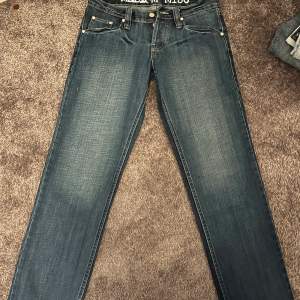 Blåa lågmidjade trendiga jeans. Storlek M men passar även S beroende på hur man vill att de ska sitta. Väldigt långa i modellen