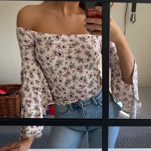 Topp med vida armar - Jättefin blommig top med vida armar som går att bära off shoulder.